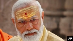 FILE- Indian Prime Minister Narendra Modi has sandalwood paste and vermilion applied on his forehead during the inauguration of Kashi Vishwanath Dham Corridor in Varanasi, India, Dec. 13, 2021. 