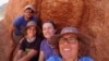 In this undated photo provided to the Associated Press by Stellenbosch University, researcher Michele Francis, right, and other researchers pose next to an ancient termite mound in Namaqualand, South Africa. 