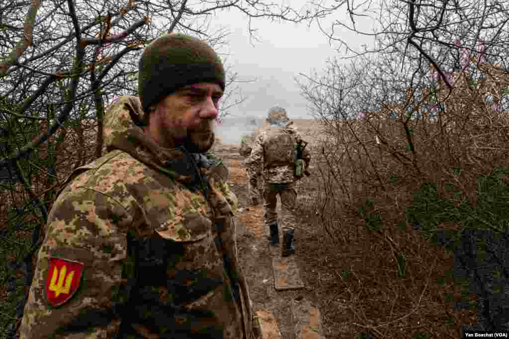 A soldier takes guard in an artillery position near Kupiansk, a city that was occupied by Russian forces and retaken by Ukrainians by the end of 2022, March 6, 2024. 