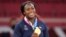 FILE - Clarisse Agbegnenou of France celebrates with her gold medal for the women's under 63kg judo match at the Summer Olympics in Tokyo, July 27, 2021.