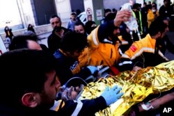 Rescue workers pull out Samir Muhammed Accar, a Syrian migrant, from a collapsed building in Antakya, Turkey, Feb. 18, 2023.