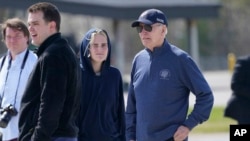 U.S. President Joe Biden and his granddaughter Maisy Biden stretch their legs during a refueling stop at Elmendorf Air Force Base in Anchorage, Alaska, May 17, 2023.