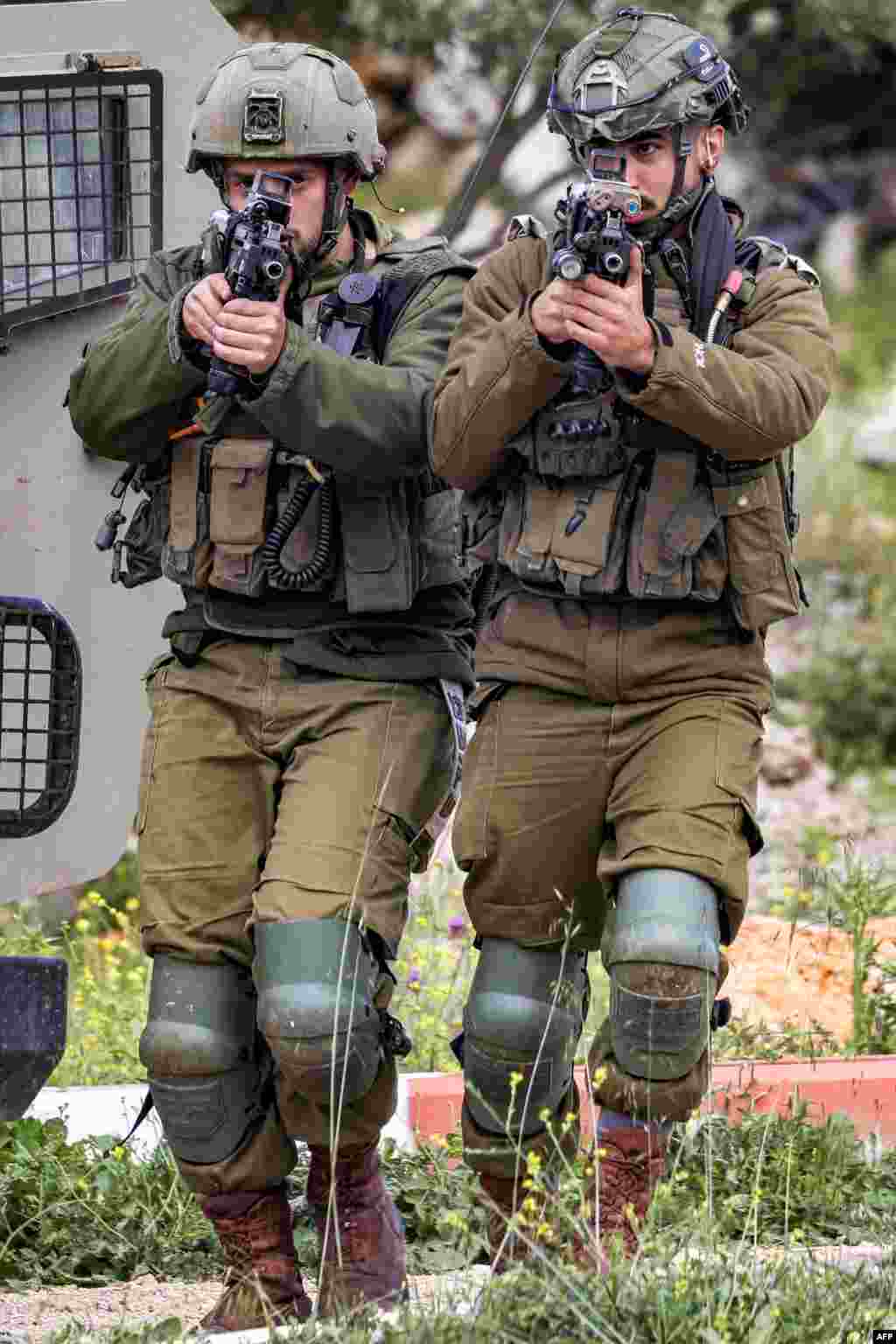 Israeli soldiers sweep an area during an army operation near the settlement of Elon Moreh in the occupied West Bank near Nablus.