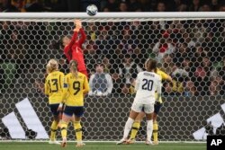 Sweden's goalkeeper Zecira Musovic, top, saves a ball during the Women's World Cup round of 16 soccer match between Sweden and the United States in Melbourne, Aug. 6, 2023.