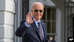FILE — U.S. President Joe Biden waves as he walks to Marine One to depart the South Lawn of the White House in Washington, Dec. 5, 2023. 