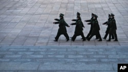 Soldiers wearing face masks march outside the Great Hall of the People in Beijing, March 3, 2023. 