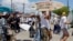 Locals march to protest the disappearance of foreign surfers in Ensenada, Mexico, May 5, 2024. Mexican authorities said Friday that three bodies were recovered in an area of Baja California near where two Australians and an American had gone missing.