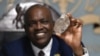 Botswana's President Mokgweetsi Masisi holds a large diamond discovered in his country, at his office in Gaborone, Aug. 22, 2024.