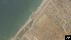 This satellite picture taken by Planet Labs PBC show the construction of a new aid port near Gaza City, Gaza Strip, on April 18, 2024. The port is being built ahead of a U.S. military-led operation to deliver food and other aid. (Planet Labs PBC via AP)