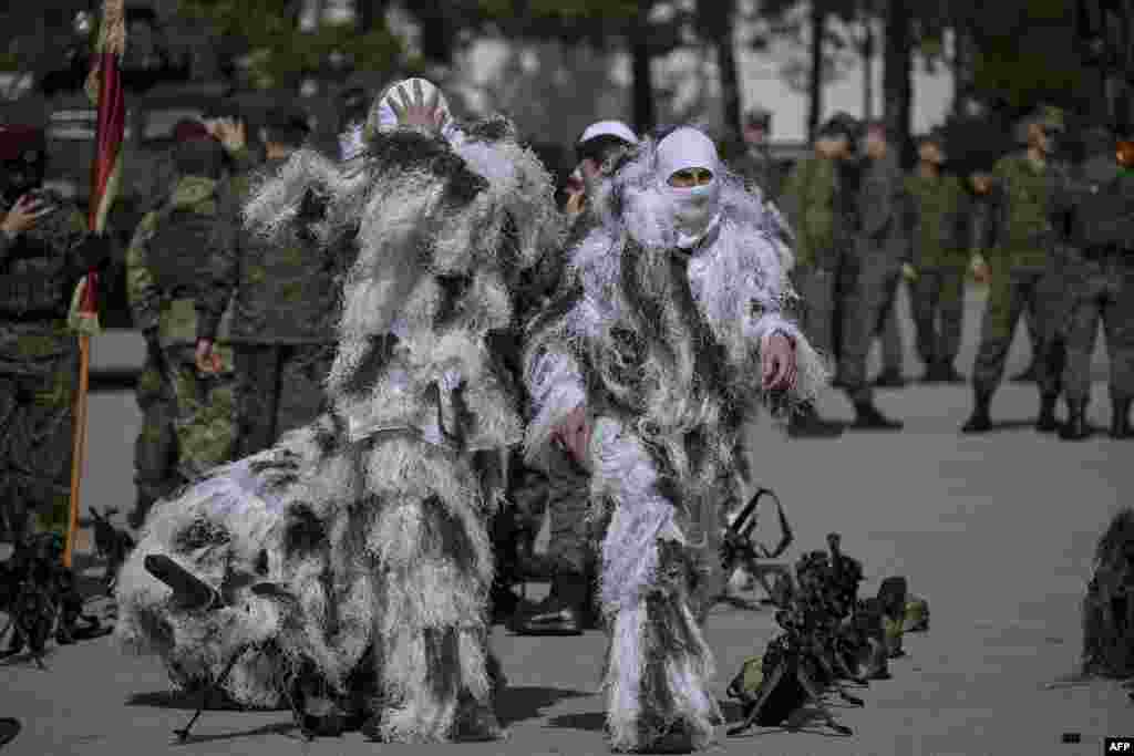 Members of the Kosovo Security Force (KSF) get ready to take part in a ceremony marking the 26th anniversary of the killing of Kosovo Liberation Army (KLA) founding member and commander Adem Jashari, in Pristina.