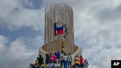 FILE - Supporters of Niger's ruling junta hold a Russian flag at the start of a protest called to fight for the country's freedom and push back against foreign interference in Niamey, Niger on Thursday, Aug. 3, 2023.