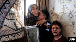 Children react to an Israeli bombardment as they take refuge at the school run by the UN Relief and Works Agency for Palestine Refugees (UNRWA) in Al-Nuseirat in the central Gaza Strip, July 6, 2024 