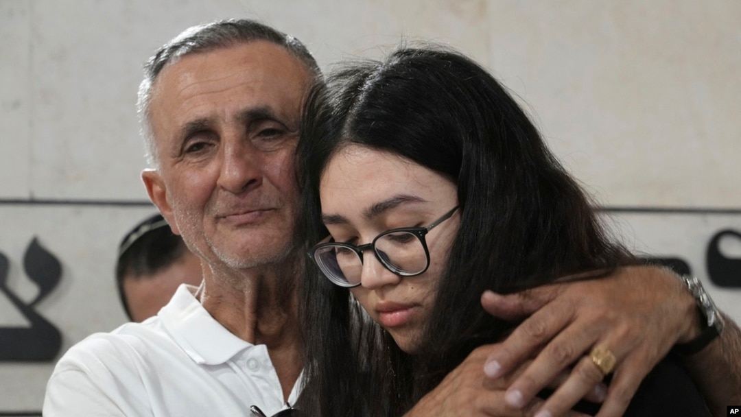 Freed Israeli hostage Noa Argamani, right, hugs her father Yakov, at the funeral for his wife and her mother Liora Argamani, in Beersheba, Israel, July 2, 2024.