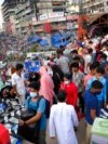 FILE - People shop at a market in Dhaka, Bangladesh, July 16, 2021. According to the Bangladesh Bureau of Statistics, the country's GDP expanded by 3.78% in the second quarter of the current fiscal year, down from 7% a year earlier. 