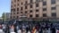 In this photo released by Suwayda24, people stage a protest in the southern city of Sweida, Syria, Aug 22, 2023. 