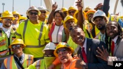 FILE - Ward 8 Councilmember Trayon White, Sr., right, and others pose for a photo after a ceremony to open the new Frederick Douglass Memorial Bridge in Washington, D.C., Sept. 7, 2021.