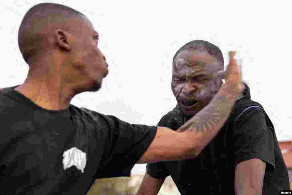 Contestants take part in a slap fighting competition in Kagiso township, west of Johannesburg, South Africa.