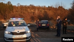 Police work in Bulgaria, near where, according to the Bulgarian Interior Ministry, at least 18 people were found dead in an abandoned truck on Feb. 17, 2023. 