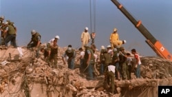 FILE - Rescue workers sift through the rubble of the U.S. Marine base in Beirut in Oct. 23, 1983, following a massive bomb blast that destroyed the base and killed 241 American servicemen.