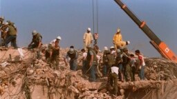 FILE - Rescue workers sift through the rubble of the U.S. Marine base in Beirut in Oct. 23, 1983, following a massive bomb blast that destroyed the base and killed 241 American servicemen.