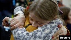 Valeriia, who went to a Russian-organized summer camp from non-government controlled territories and was then taken to Russia, embraces her mother Anastasiia after returning via the Ukraine-Belarus border, in Kyiv, Ukraine, April 8, 2023.