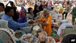 People buy grocery items at a bazaar, set up by the provincial government to provide items on discounted rates, in Karachi, Pakistan, April 12, 2023. The cash-strapped South Asian country is still waiting for its $1.1 billion bailout package from the IMF. 