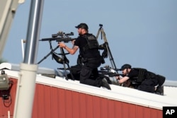 Police snipers return fire after shots were fired while Republican presidential candidate former President Donald Trump was speaking at a campaign event in Butler, Pennsylvania, July 13, 2024.