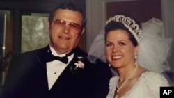 This 1997 photo provided by Kelly Forrester shows her with her father, Virgil Michlitsch, at her wedding. Forrester lost her father to COVID in 2020 and survived her own bout.