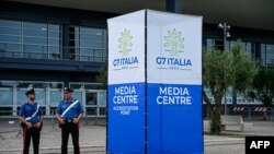 Police officers stand outside the G7 Italy 2024 media center in Bari, Italy, on June 11, 2024. 