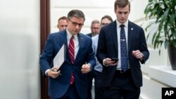 House Speaker Mike Johnson (L) arrives for a closed-door meeting with Republican colleagues at the Capitol in Washington on April 15, 2024.