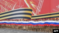 FILE: Russian Patriotic Youth movement members hold a giant national flag during the general rehearsal for the Victory Day parade in Saint Petersburg on May 7, 2023. - Russia will celebrate the 78th anniversary of the 1945 victory over Nazi Germany on May 9.