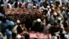 Relatives and mourners gather around the caskets of victims who were killed in Sunday's suicide bomber attack in the Bajur district of Khyber Pakhtunkhwa, Pakistan, July 31, 2023.