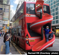 A double-decker bus with a slide on the back is one of the Tommy Fung's playful images of Hong Kong. (Courtesy: Surreal HK)