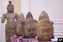 In this photo released by Agence Kampuchea Press (AKP), artifact statues are displayed during a ceremony for the return of artifacts at Peace Palace in Phnom Penh, Cambodia, Thursday, Aug. 22, 2024. (AKP via AP)