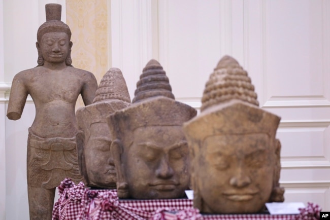 In this photo released by Agence Kampuchea Press (AKP), artifact statues are displayed during a ceremony for the return of artifacts at Peace Palace in Phnom Penh, Cambodia, Thursday, Aug. 22, 2024. (AKP via AP)