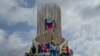 Supporters of Niger's junta hold a Russian flag at a protest called to push back against foreign interference in Niamey on Aug. 3, 2023. Niger is the most recent point of potential friction between China and Russia's paramilitary Wagner Group.