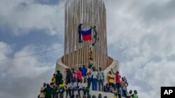 Supporters of Niger's junta hold a Russian flag at a protest called to push back against foreign interference in Niamey on Aug. 3, 2023.