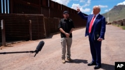 Republican presidential nominee Donald Trump talks with Paul Perez, president of the National Border Patrol Council, a labor union, as he tours the southern border with Mexico, Aug. 22, 2024, in Sierra Vista, Ariz.