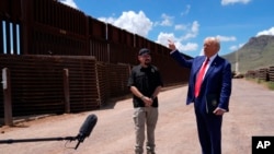 FILE - Republican presidential nominee Donald Trump talks with Paul Perez, president of the National Border Patrol Council, as he tours the southern border with Mexico, Aug. 22, 2024, in Sierra Vista, Ariz.