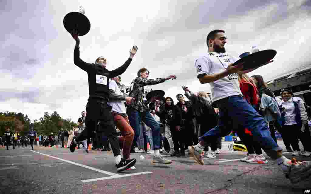 Waiters run with trays during a 400-meter race of waiters and waitresses in Moscow.