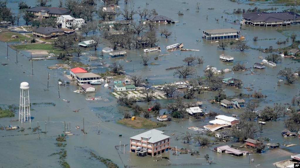 FILE - Buildings and homes are flooded in the aftermath of Hurricane Laura near Lake Charles, La., on Aug. 27, 2020. (AP Photo/David J. Phillip, File)