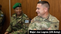 Botswana Defense Forces 1st Lieutenant Maria Gabaikanngwe and U.S. Army Master Sergeant Hernan Briones take part in a planning meeting for the South Accord 2024 exercises in Gaborone, Botswana, on June 19, 2024. The exercises, in Botswana, wrap up on Aug. 15, 2024.