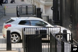 A car is stopped after colliding with the gates of Downing Street in London, May 25, 2023.