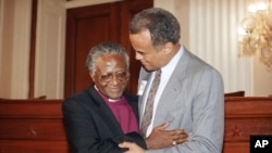 FILE - Actor Harry Belafonte, right, embraces Bishop Desmond Tutu during a gathering on Capitol Hill in Washington, May 30, 1986 where a newly-released documentary about apartheid was shown.