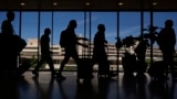 Travelers walk through the Philadelphia International Airport, July 3, 2024. 