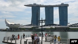 People take pictures on the jetty at Marina Bay waterfront in Singapore, Nov. 17, 2023.
