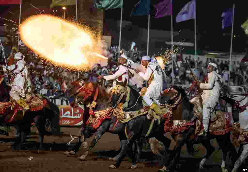 Horsemen fire their rifles during a performance to celebrate the annual Moussem festival in El Jadida, Morocco, Aug. 6, 2023. 