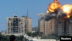 An explosion occurs following an Israeli air strike on a residential building, amid the Israel-Hamas conflict, in Nuseirat in the central Gaza Strip, July 20, 2024.