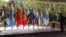FILE - A video journalist films flags of countries participating in the Shanghai Cooperation Organization foreign ministers’ meeting, outside the venue in Goa, India, May 4, 2023.