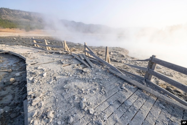 This photo released by the National Park Service shows a boardwalk damaged by a hydrothermal explosion at Biscuit Basin in Yellowstone National Park, Wyo., July 24, 2024.